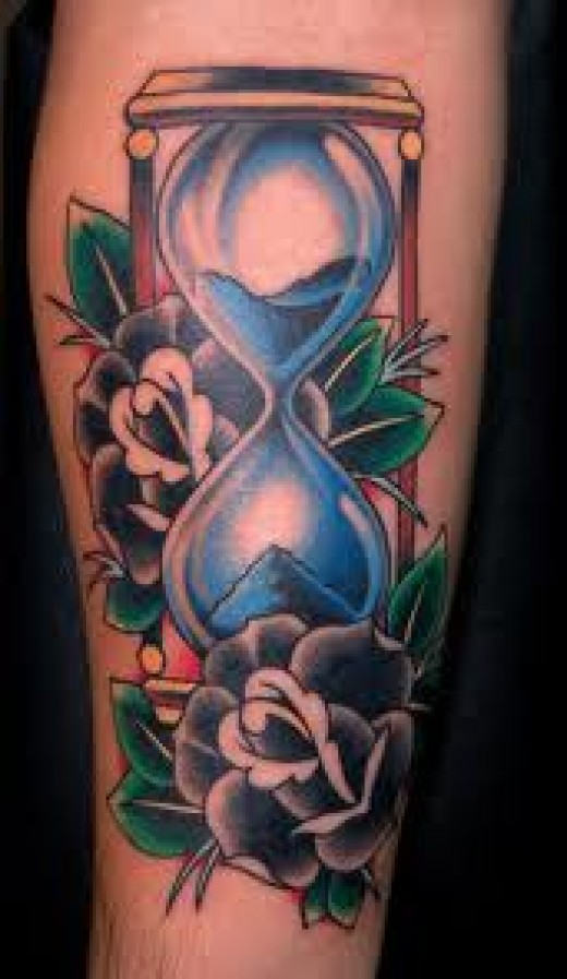 Blue Sand In Hourglass With Flowers Tattoo Design