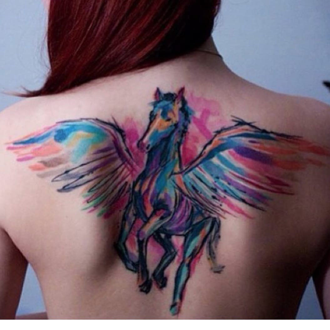 Colorful Watercolor Unicorn Tattoo On girls Back