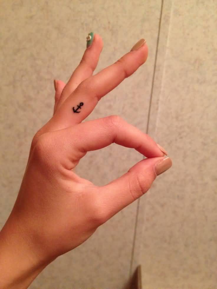 Cute Small Anchor Tattoo On Middle Finger