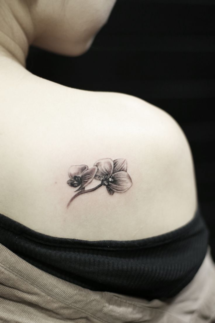 Cute Small Gray Ink Orchid Tattoo On Right Back Shoulder