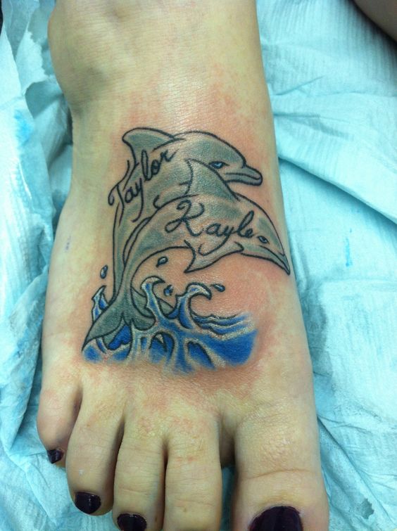 Dolphin Couple Tattoo With Water wave On Foot