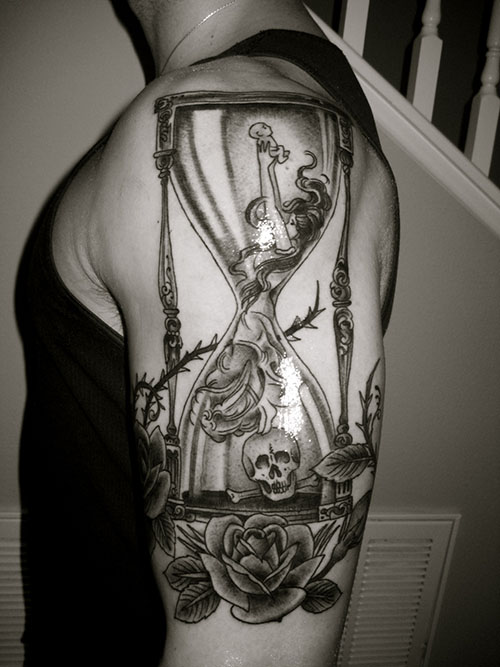 Girl Inside Hourglass With Skull And flowers Tattoo On Half Sleeve