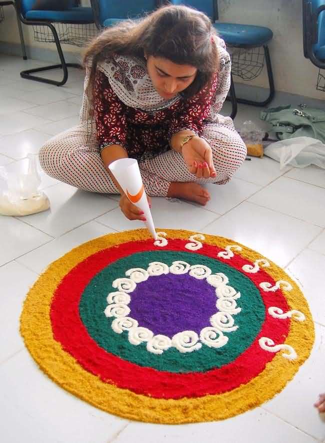Girl Making Beautiful Rangoli Design For Diwali Decoration