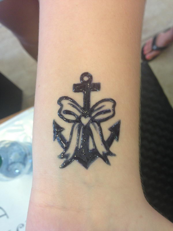 Glossy Anchor And bow Tattoo On Wrist