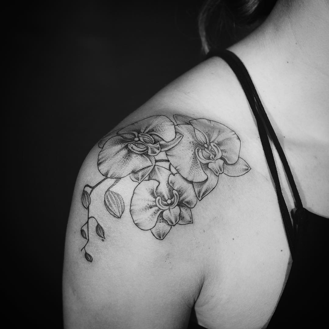 Gray Ink Orchid Tattoo On Collar Bone