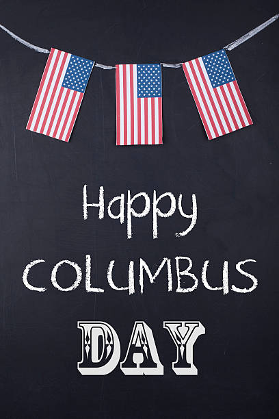 Happy Columbus Day Hanging American Flags On Black Board