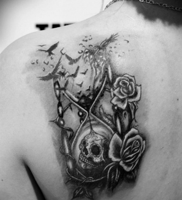 Hourglass And skull With flower tattoo on girls back
