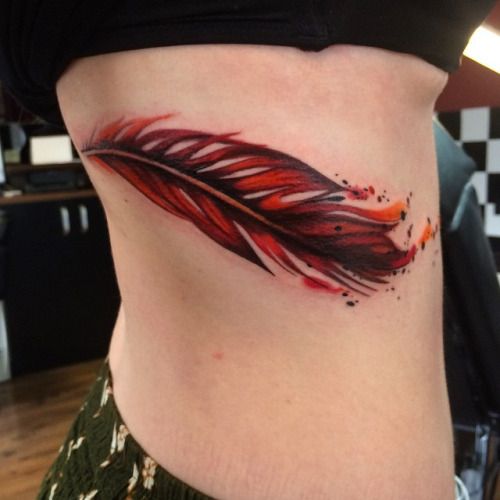 Orange And Black Feather Tattoo On Side Rib