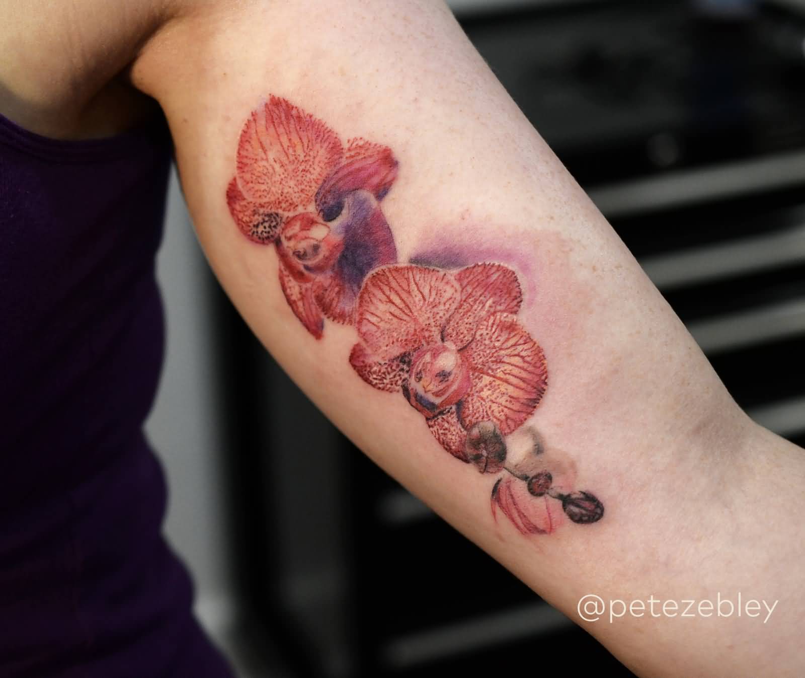 Pretty Red Orchid Tattoo On Bicep