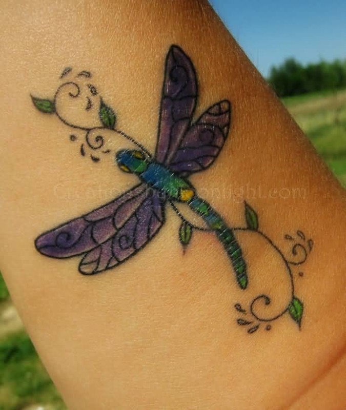 Purple And Green Dragonfly Tattoo On Forearm