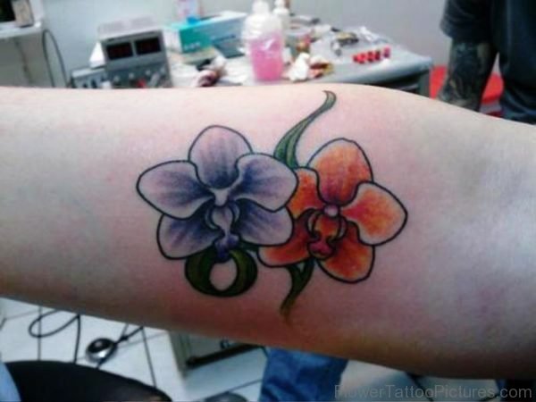Purple And Orange Orchid Tattoo On Forearm
