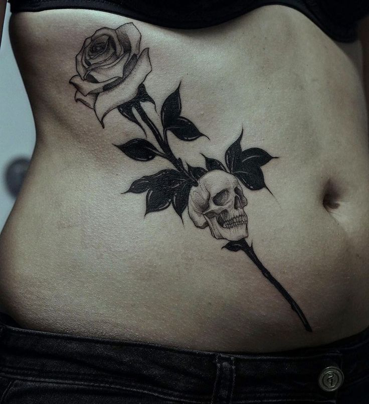 Rose Bud and small Skull Tattoo On Stomach