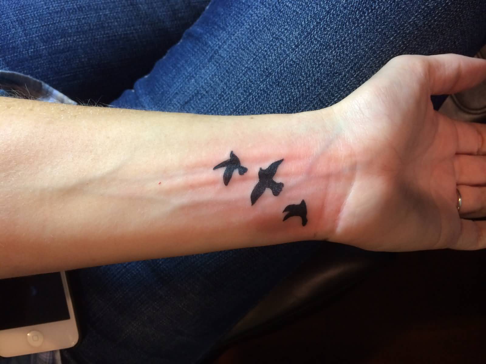 Silhouette Flying Birds Tattoo On Wrist