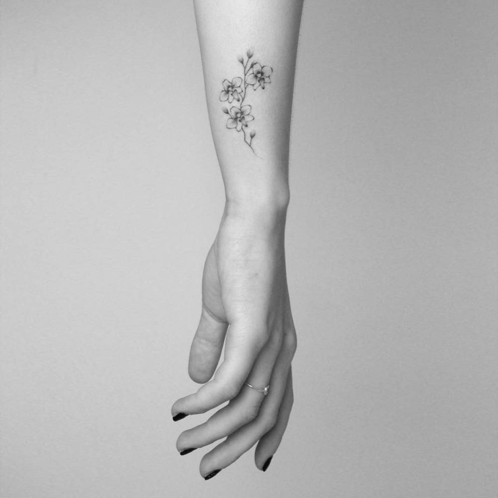 Small Branch Of Orchid Tattoo On Forearm