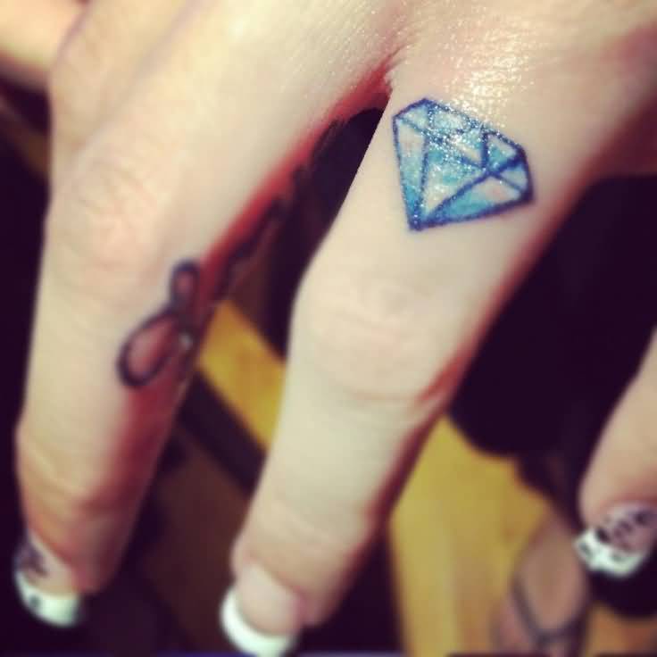 Tiny Blue Diamond Tattoo On Finger