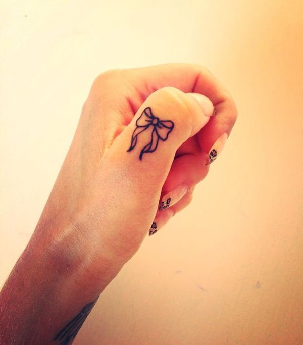 Tiny Bow Tattoo On Thumb