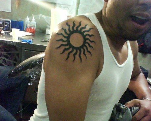 Tribal Sun Tattoo On The Upper Arm For Men