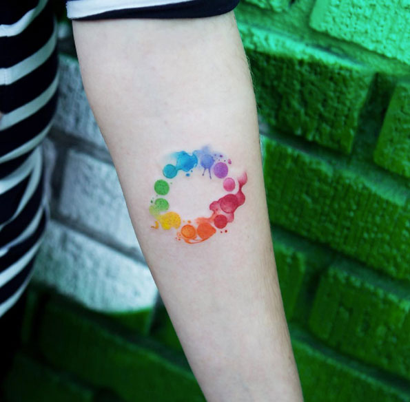 Watercolor Spots Wheel tattoo On Forearm