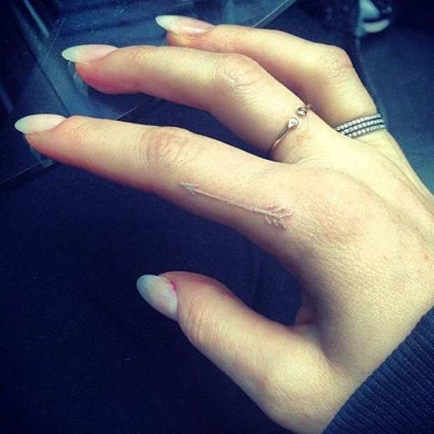White Ink Cute Small Arrow Tattoo on finger