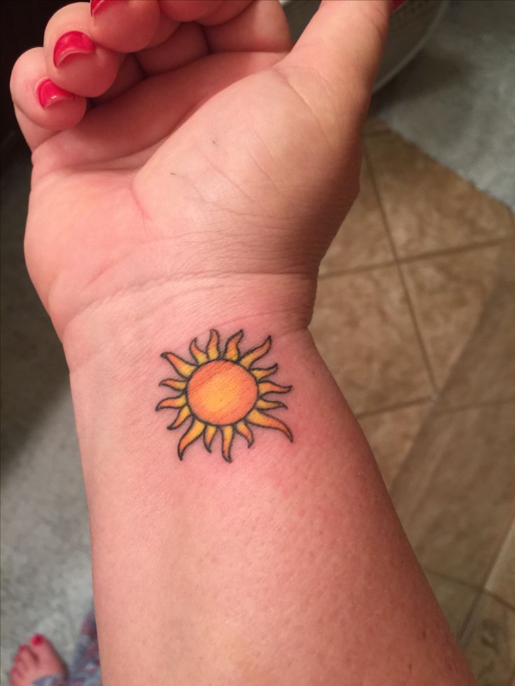 Yellow And Orange Sun Tattoo On Wrist