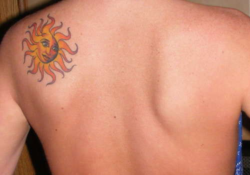 Yellow Color Sun Tattoo On Mens Back