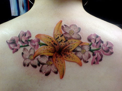 Yellow Lilly And Orchid Flower Tattoo On Upper Back