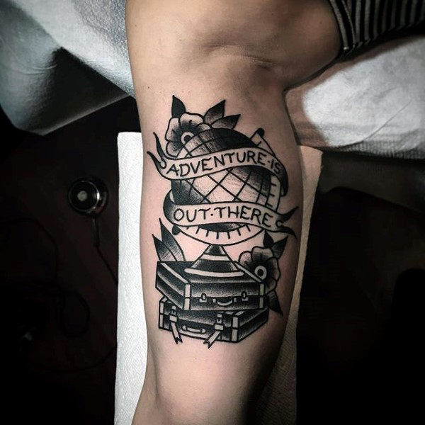 Adventure Out There Travel Tattoo on Bicep With Globe & Suitcases