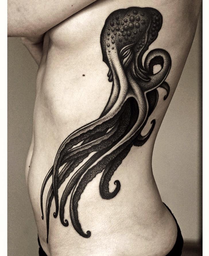 Beautiful Black Flowing Octopus Tattoo On Girl Side Rib
