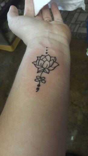 Black Ink Lotus Flower And semicolon Design Tattoo On Wrist