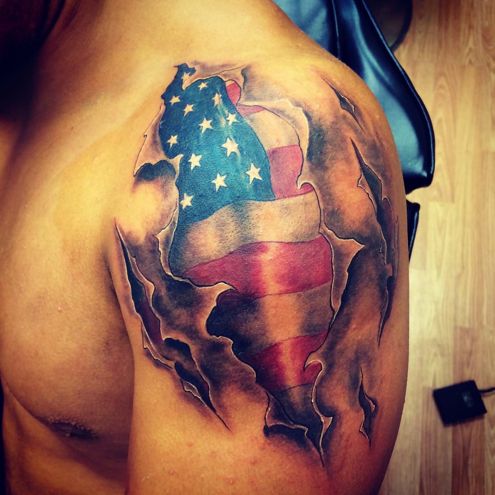Burned US Flag Tattoo On Upper Arm