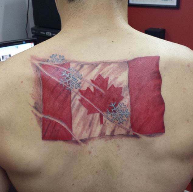 Canadian Flag With Snowflakes Tattoo Design On Back