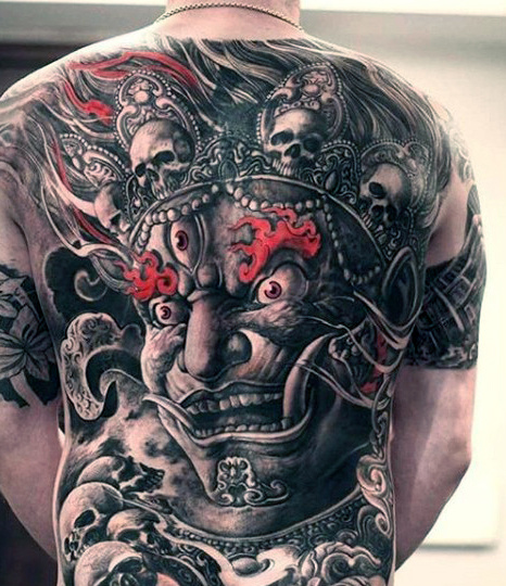 Dark Grey Three Eyed Demon Wearing Skull Crown Tattoo On Full Back