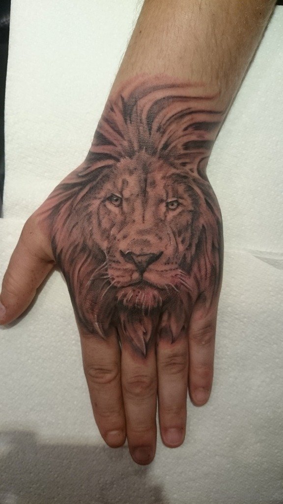 Excellent Lion Face tattoo On hand