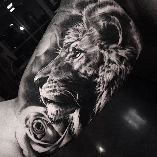 Lion Face And Rose Flower grey Ink Tattoo On Bicep