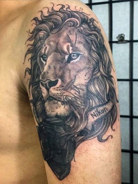 Lion Face With camera Tattoo On Upper back