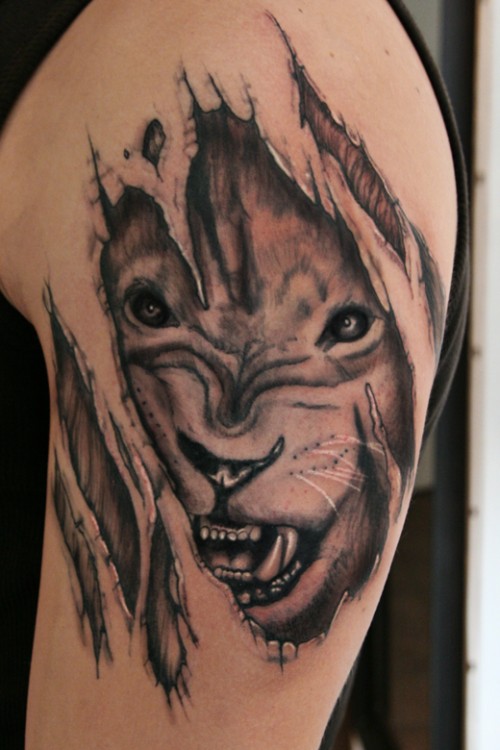 Ripped skin Lion Face Tattoo On Bicep