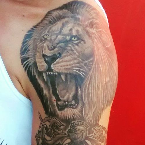 Roaring Lion With Warrior Tattoo On Upper Arm