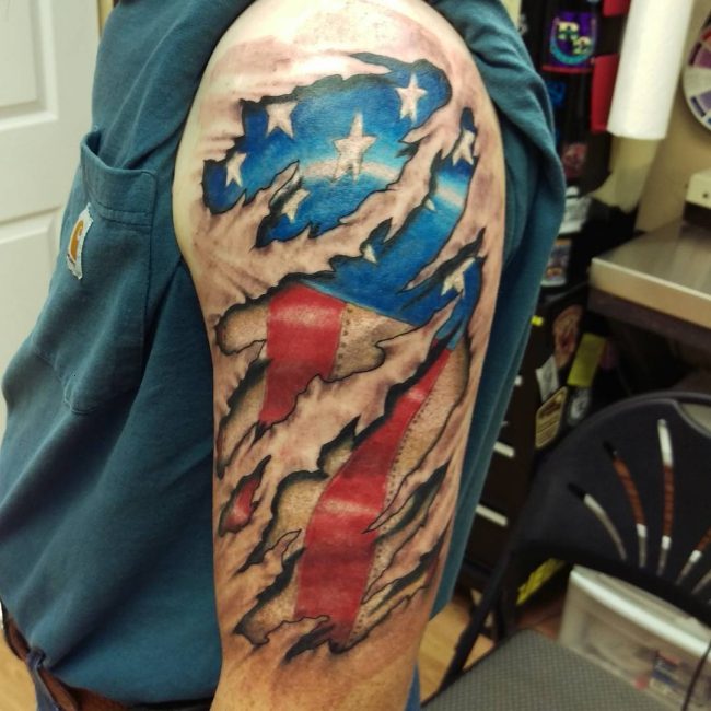Teared Skin USA Flag Tattoo On Upper Arm