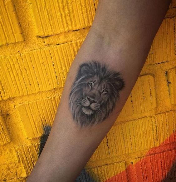 gray Ink Small Lion Face Tattoo On Forearm