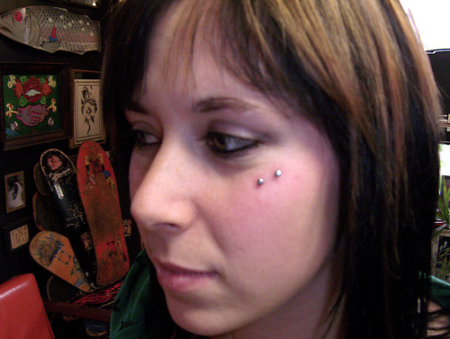 An Anti- Eyebrow Piercing With Surface Barbell