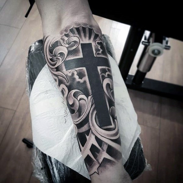 Black & Grey Mystic Cross In Clouds Tattoo Design On Forearm