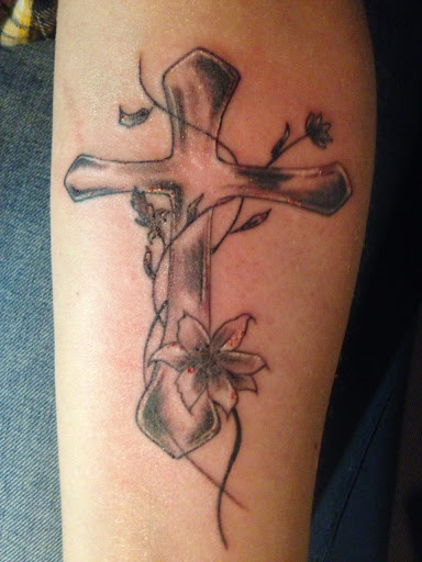 Grey Ink Cross With Flowers Tattoo Design on Forearm