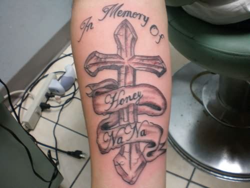 Grey Ink Memorial Cross Tattoo On Forearm