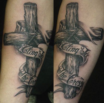 Grey Ink Wooden Cross Tattoo With Ribbon On Forearm