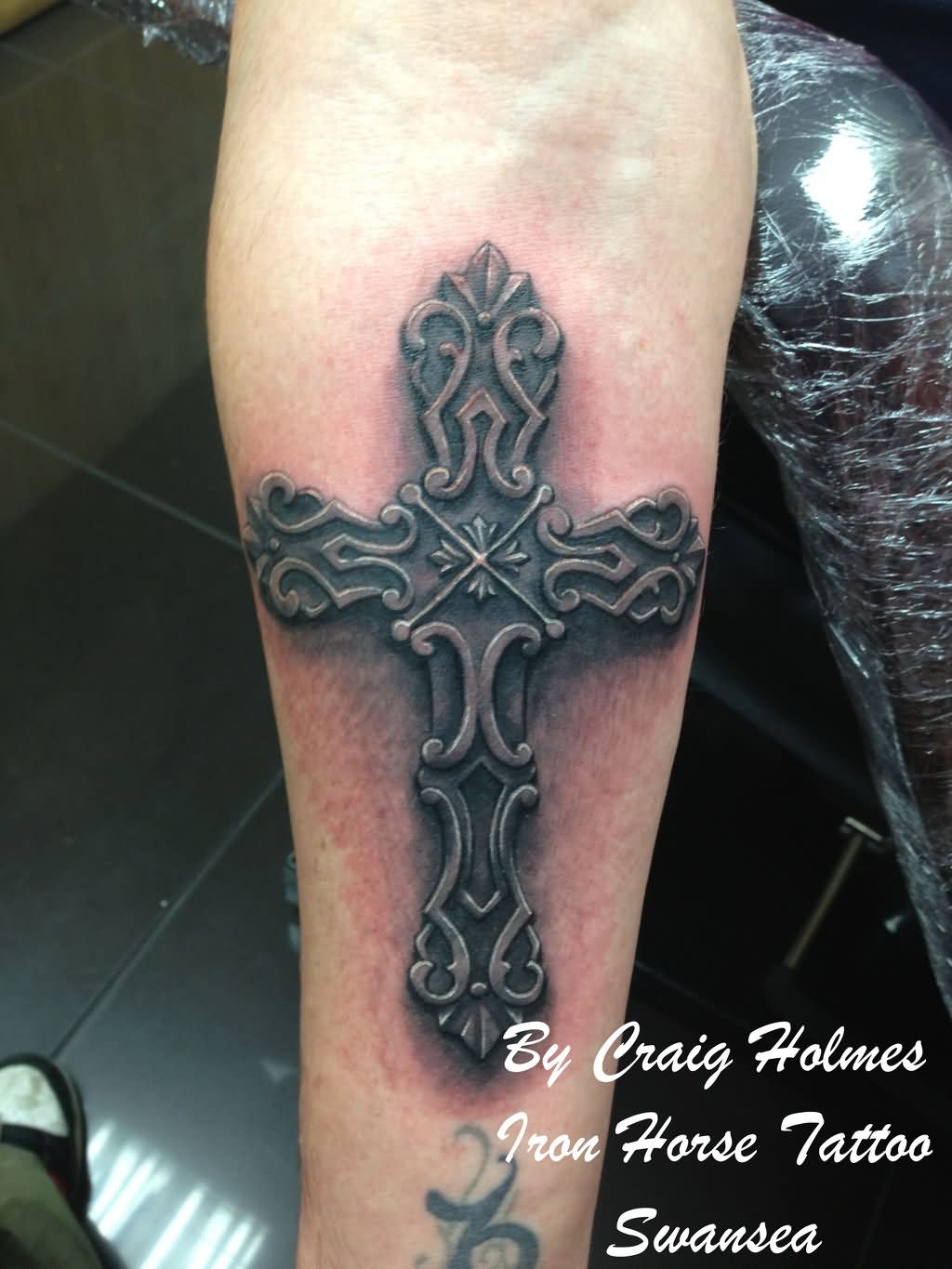 Old Dark Metallic Cross Tattoo Design On Forearm by Craig Holmes