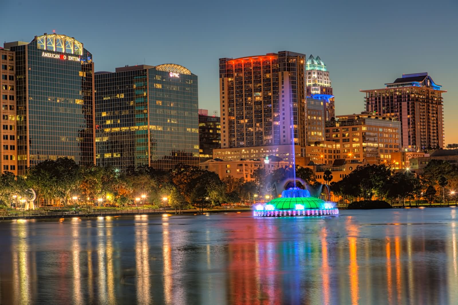 Reflections of the fountain and lights shining in Lake Eola, Orlando, FL
