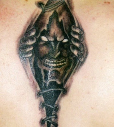 Ripped Skin Black Devil Tattoo Representing Inner Demon Trying To Come Out
