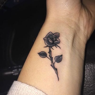 Amazing Black Small Rose Tattoo On Wrist