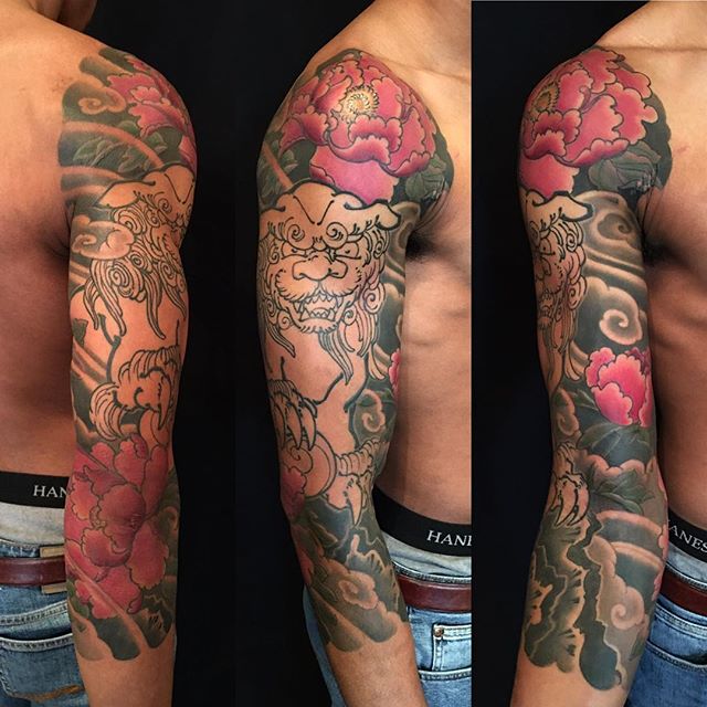 Amazing Japanese Lion With Red Flowers Tattoo On Full Sleeve