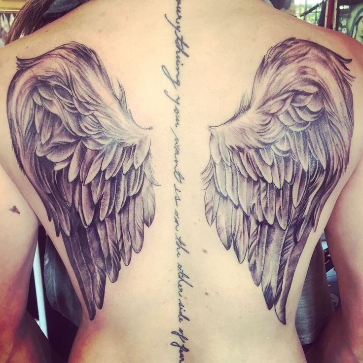 Beautiful Realistic Feathers Angel Wings Tattoo On Girl Back With Wording